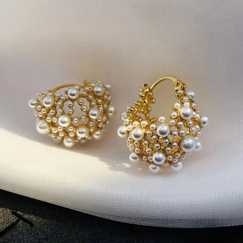 Elegant pearl-adorned hoop earrings in gold or silver. Delicate yet statement-making, crafted from stainless steel and copper with a luxurious finish. Perfect for everyday elegance or special occasions.