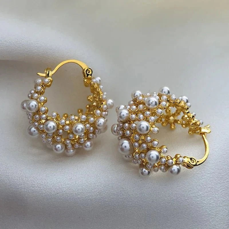 Elegant pearl-adorned hoop earrings in gold or silver. Delicate yet statement-making, crafted from stainless steel and copper with a luxurious finish. Perfect for everyday elegance or special occasions.