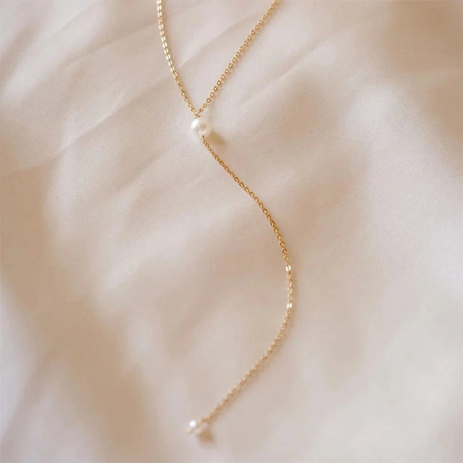 Chic and delicate gold-plated long chain necklace with pearl accents. Lightweight, durable, and perfect for adding a subtle shine to any outfit.