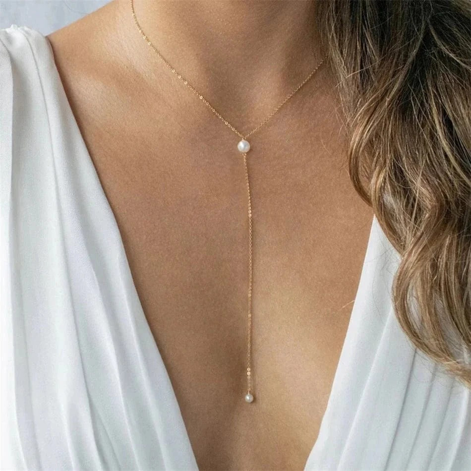 Chic and delicate gold-plated long chain necklace with pearl accents. Lightweight, durable, and perfect for adding a subtle shine to any outfit.