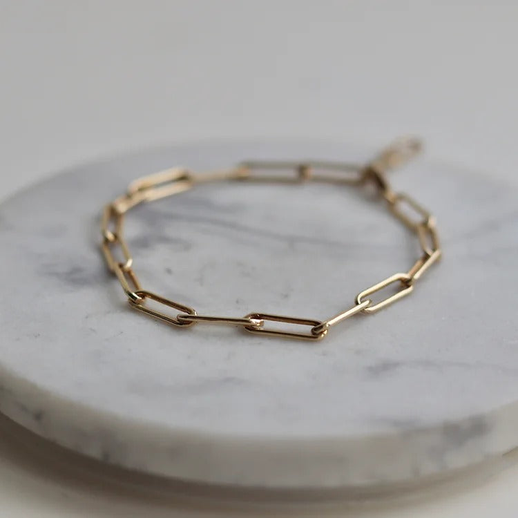 Elegant Gold Filled Paperclip Chain Bracelet with a delicate, timeless design. Tarnish and corrosion-resistant, lightweight, and adjustable for a comfortable fit. Perfect for layering or wearing alone, adding a touch of sophistication to any outfit.