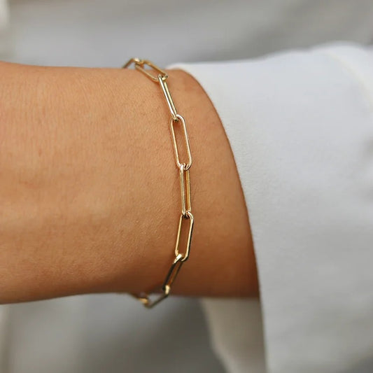 Elegant Gold Filled Paperclip Chain Bracelet with a delicate, timeless design. Tarnish and corrosion-resistant, lightweight, and adjustable for a comfortable fit. Perfect for layering or wearing alone, adding a touch of sophistication to any outfit.