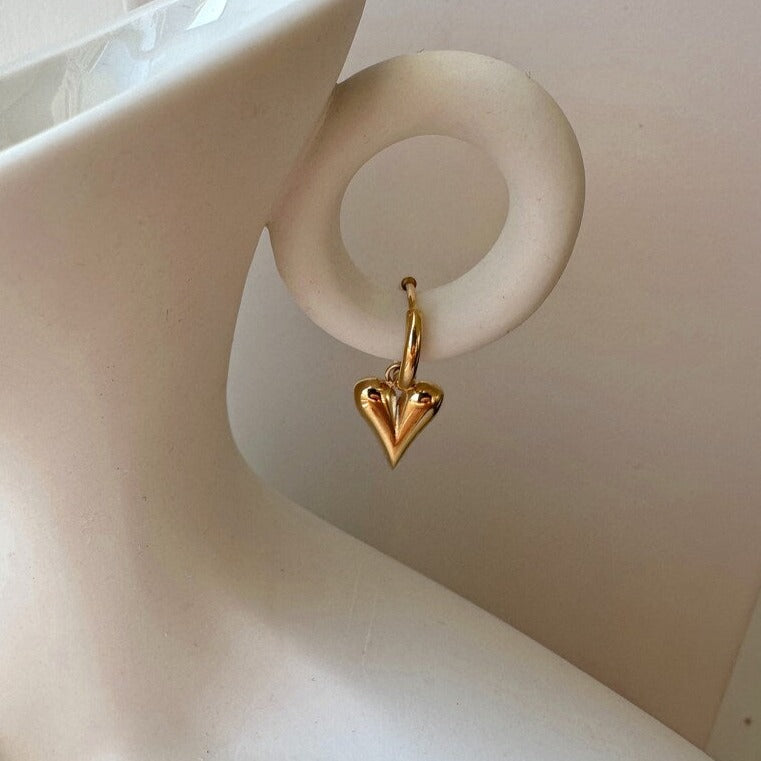 Elegant gold heart hoop earrings in 18K gold-plated stainless steel. Lightweight, hypoallergenic, and perfect for everyday wear or bridal elegance.