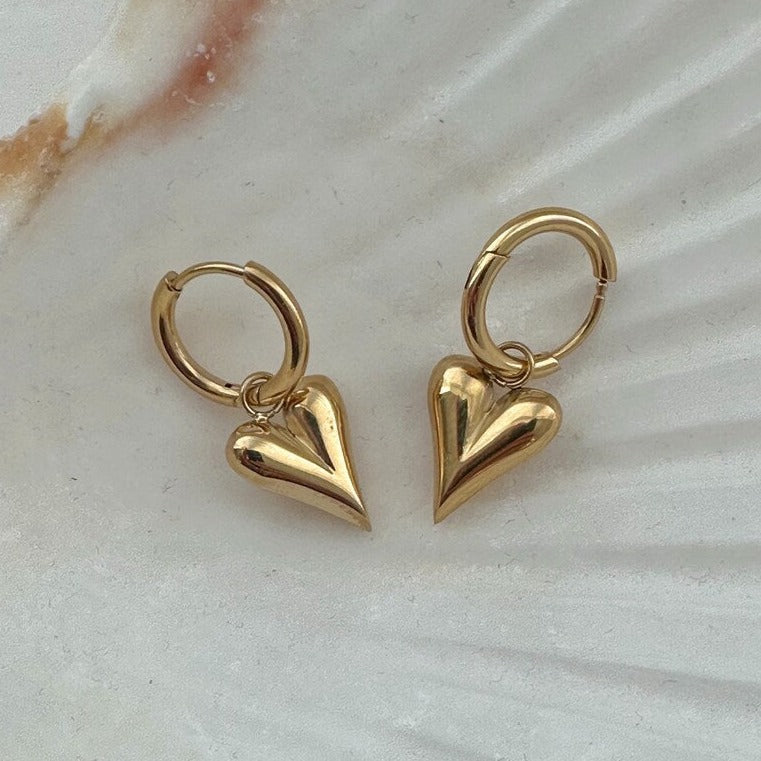 Elegant gold heart hoop earrings in 18K gold-plated stainless steel. Lightweight, hypoallergenic, and perfect for everyday wear or bridal elegance.