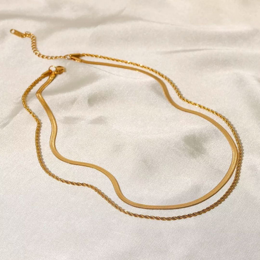 Elegant 18K gold-plated layered necklace with a herringbone choker and a delicate rope chain. Waterproof, sweatproof, and hypoallergenic for effortless elegance.